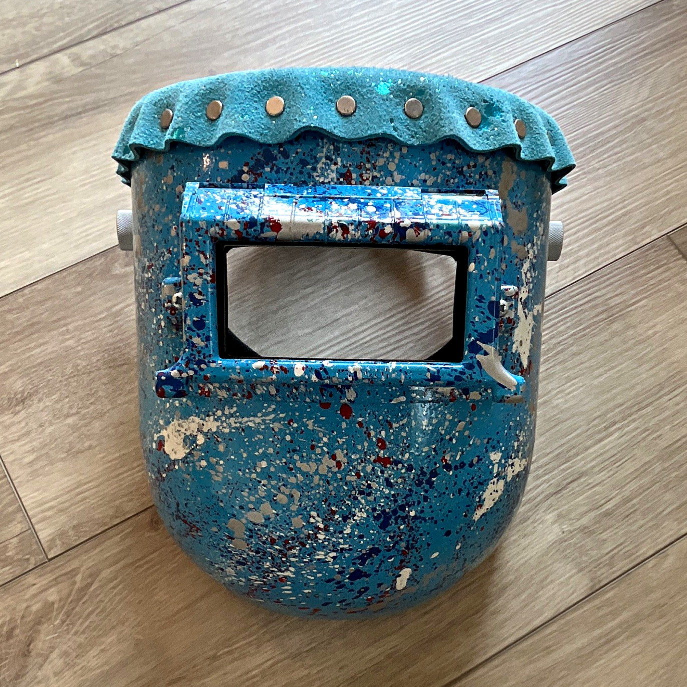 Flip lense welding hood. Custom painted with leather top Aluminum headgear knobs